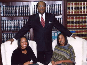 H. Lee Thompson Attorney Standing in Legal Office with Daughters Seated. Call Us Today for a Free Consultation 614-461-9000
